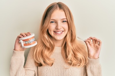 Teen with braces and aligner